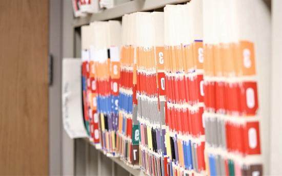 Numbered file folders on an office shelf